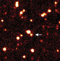 A Deep Space view of galaxies at different distance with the arrow pointing to one (LAE J1040-0130) claimed to be 14 b.l.y. from Earth.
